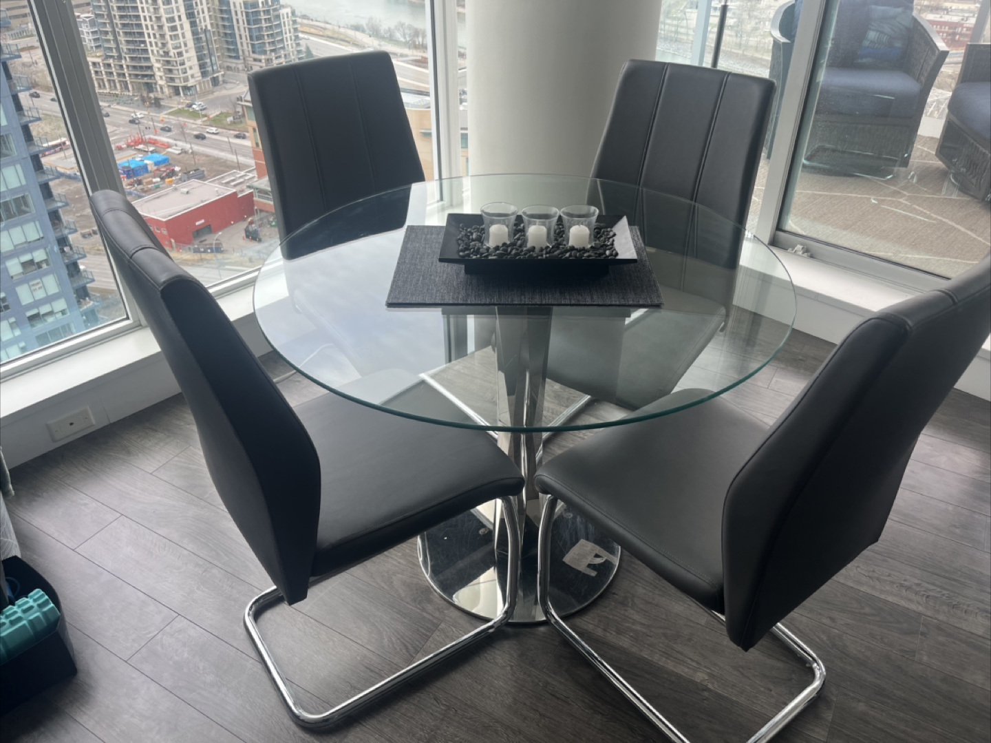 Glass-top dining table with four chairs