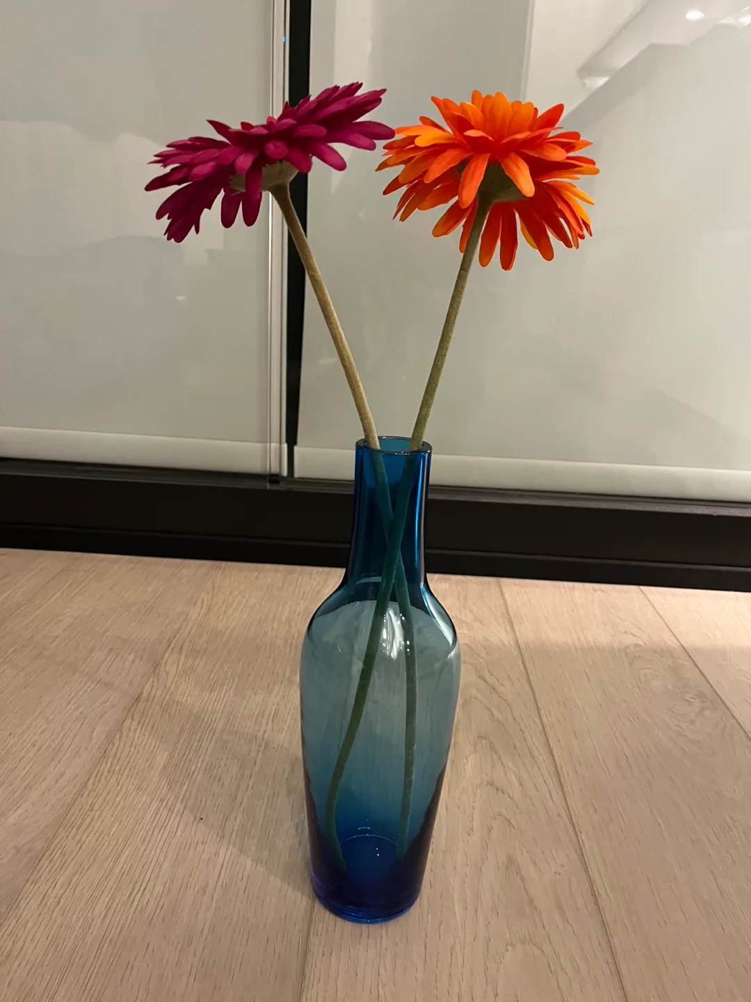 Blue glass vase with artificial flowers thumbnail