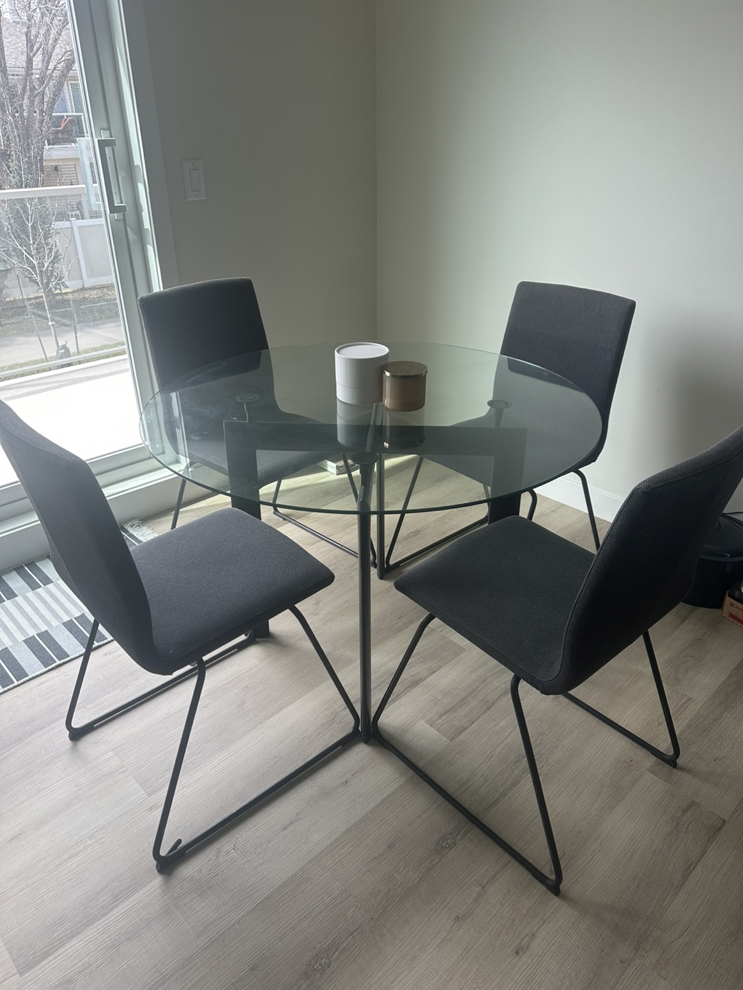 Glass-top dining table with four chairs