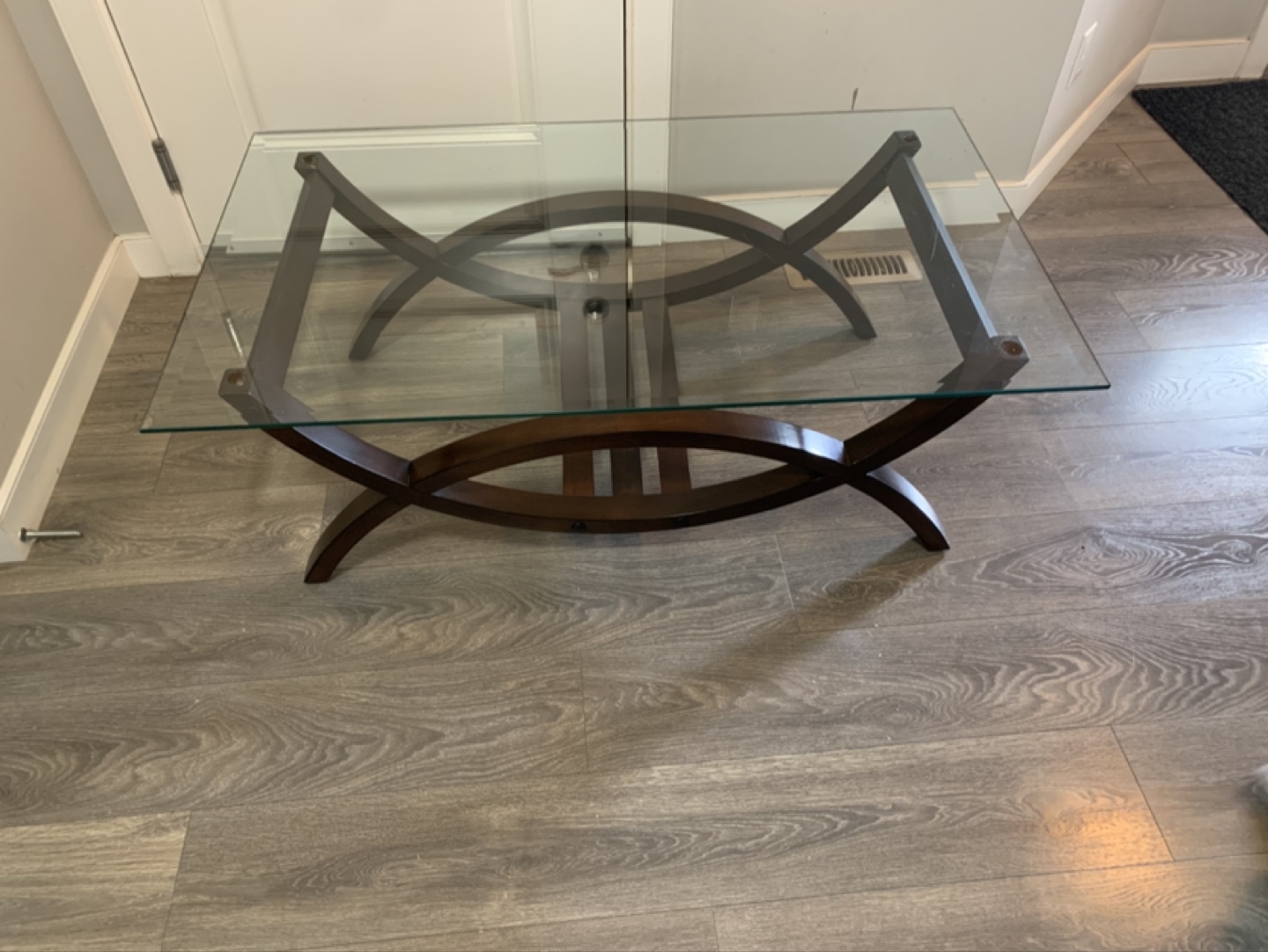 Glass top coffee table with dark brown wooden frame