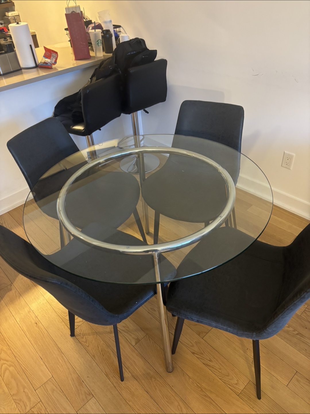 Glass Top Dining Table with Four Black Chairs