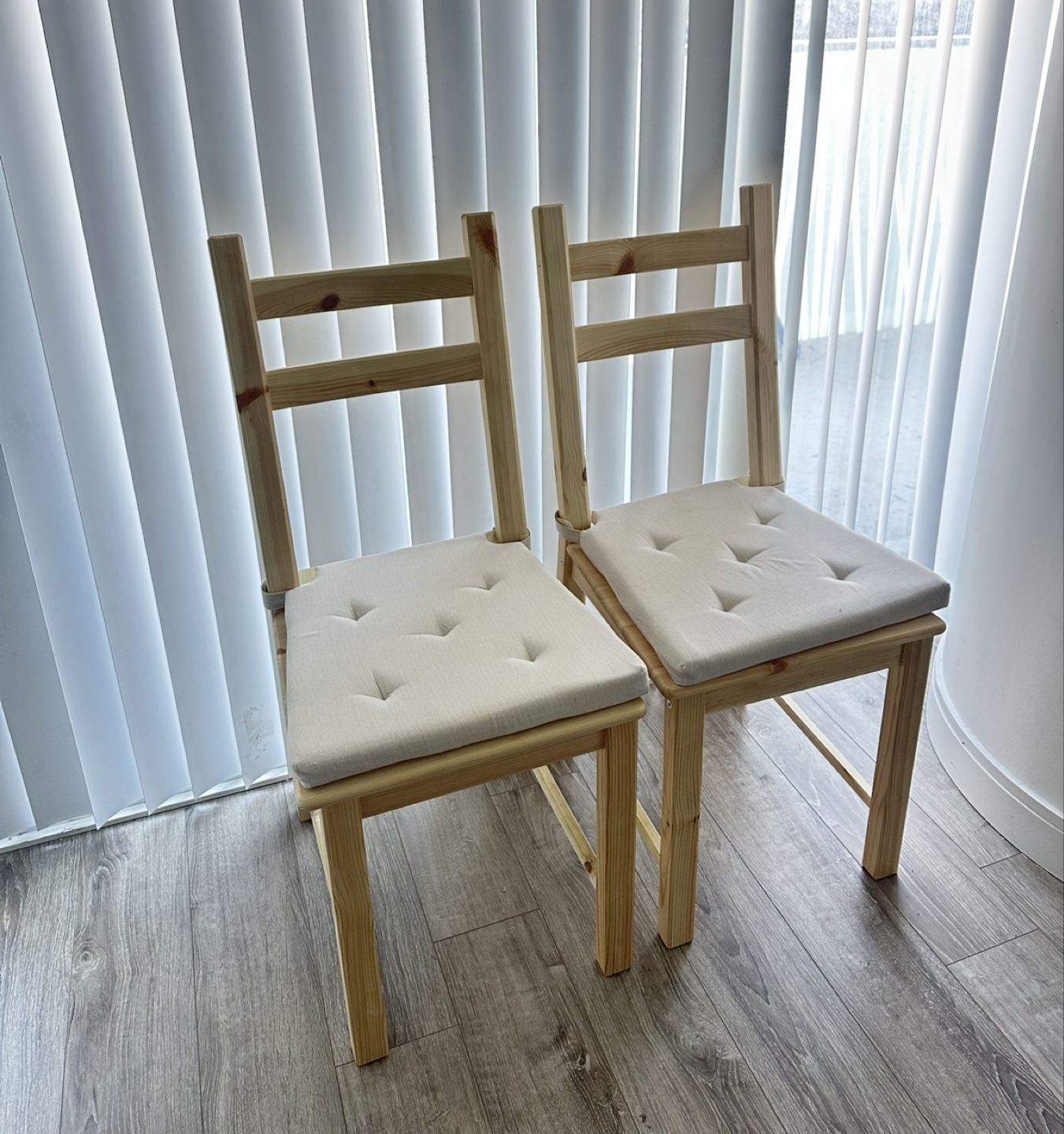 Pair of IKEA wooden chairs with cushions