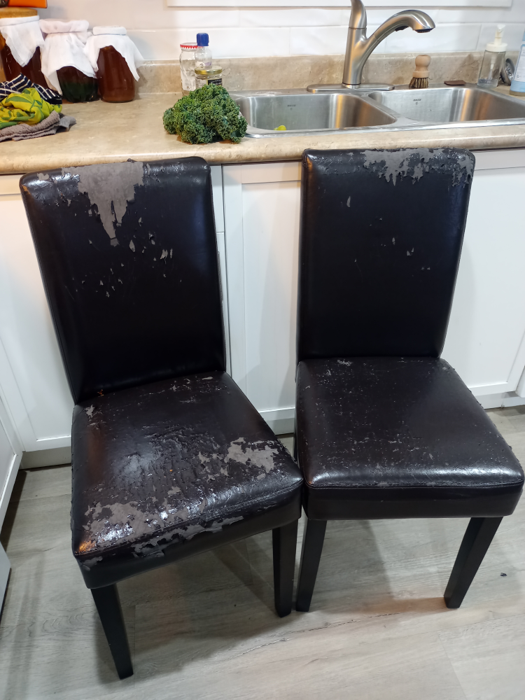 Two Damaged Black Leather Dining Chairs
