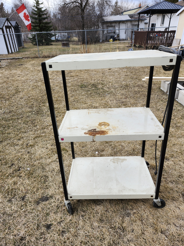 Three-shelf metal rolling cart with power strip