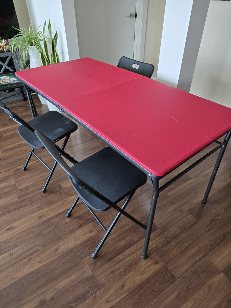 Red Folding Table and Four Black Chairs
