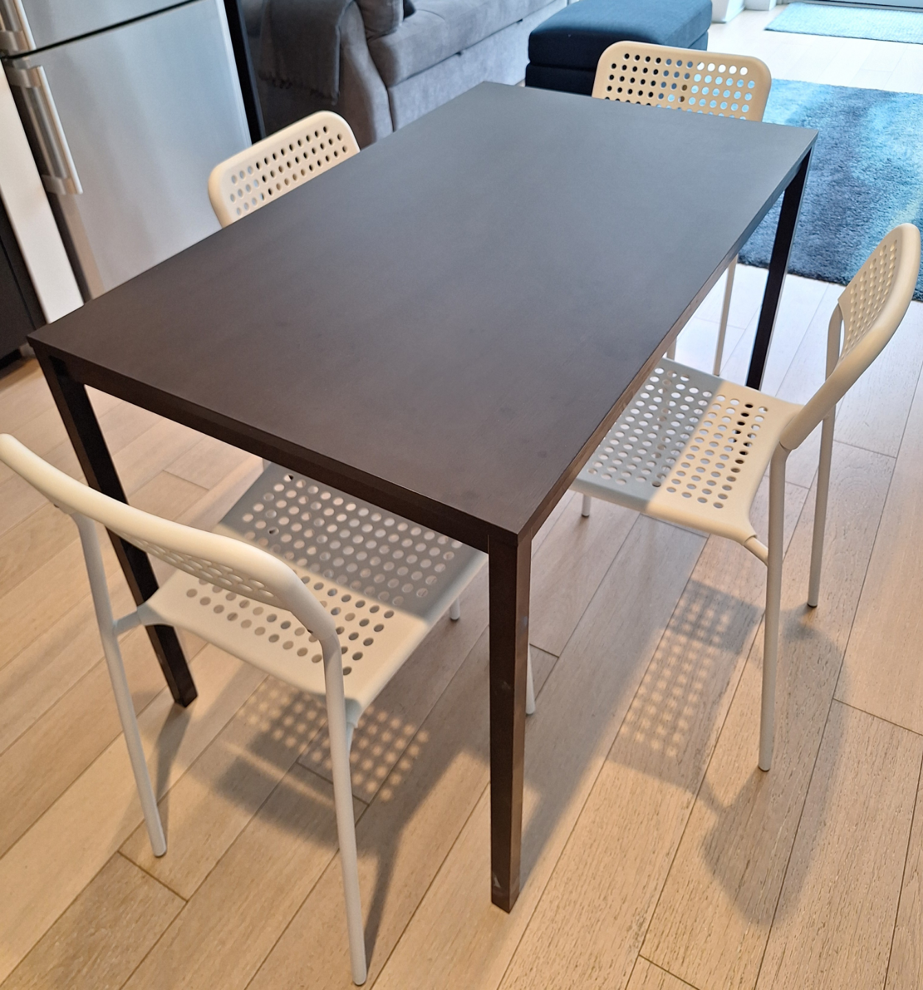 Small Dark Brown Dining Table with Four White Chairs