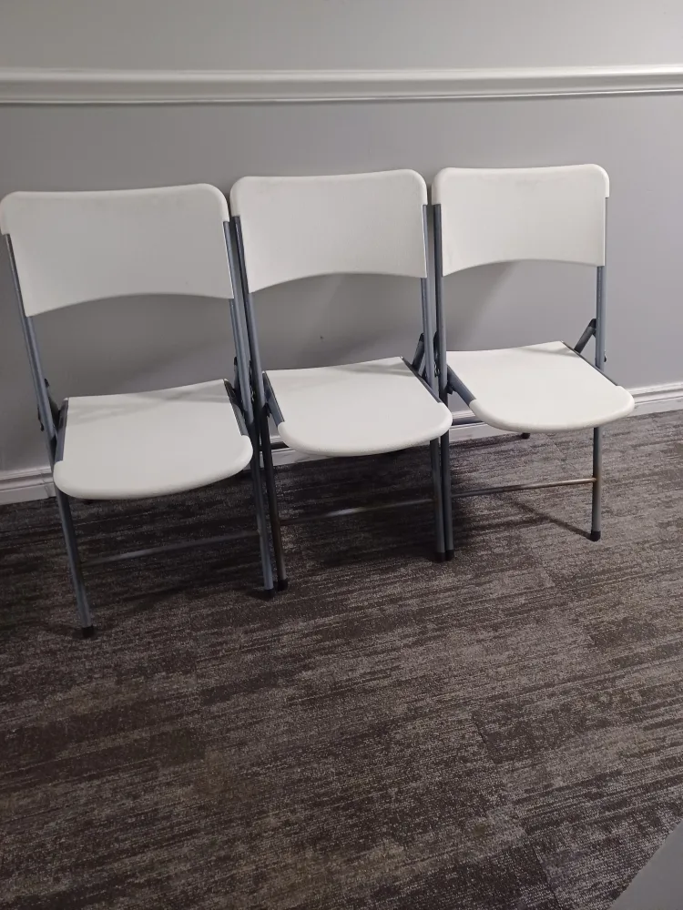 Three White Folding Chairs thumbnail
