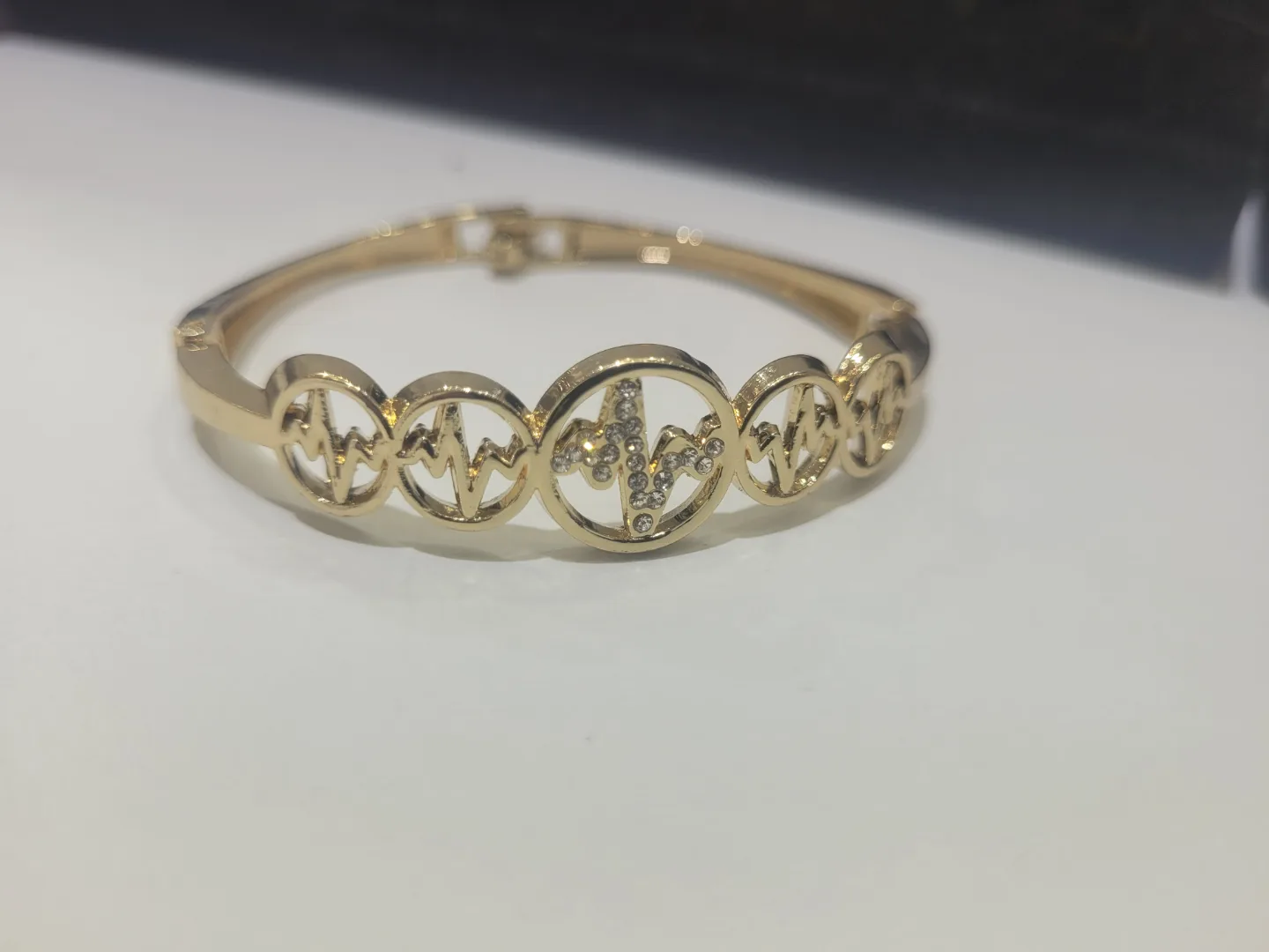 Gold Tone Hinged Bracelet with Heartbeat Design thumbnail