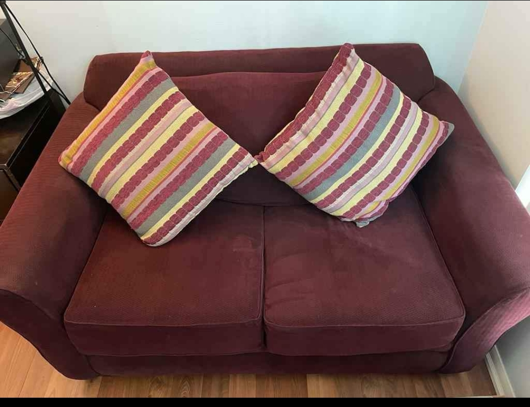 Burgundy Loveseat with Two Pillows