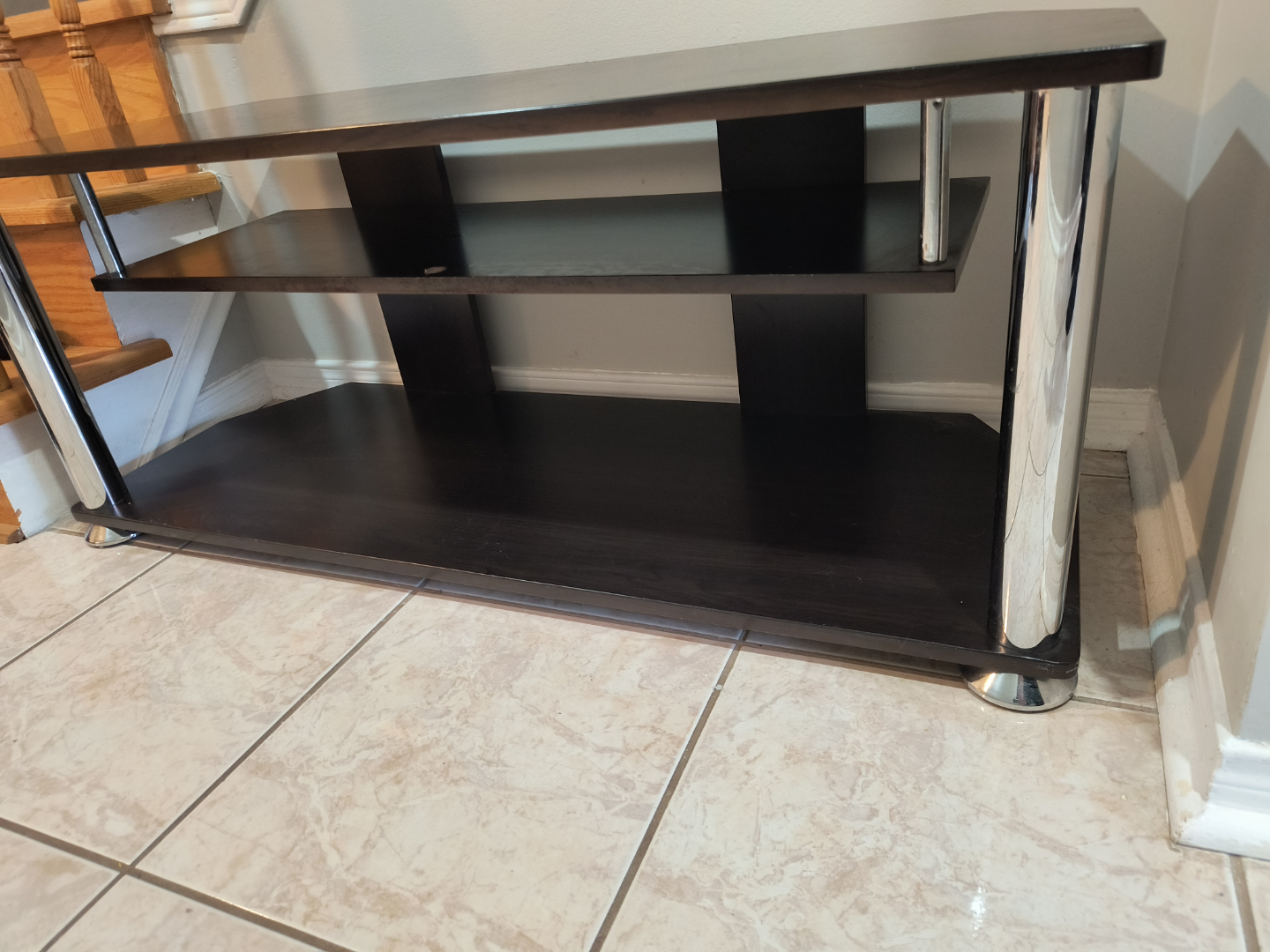 Dark brown TV stand with chrome legs