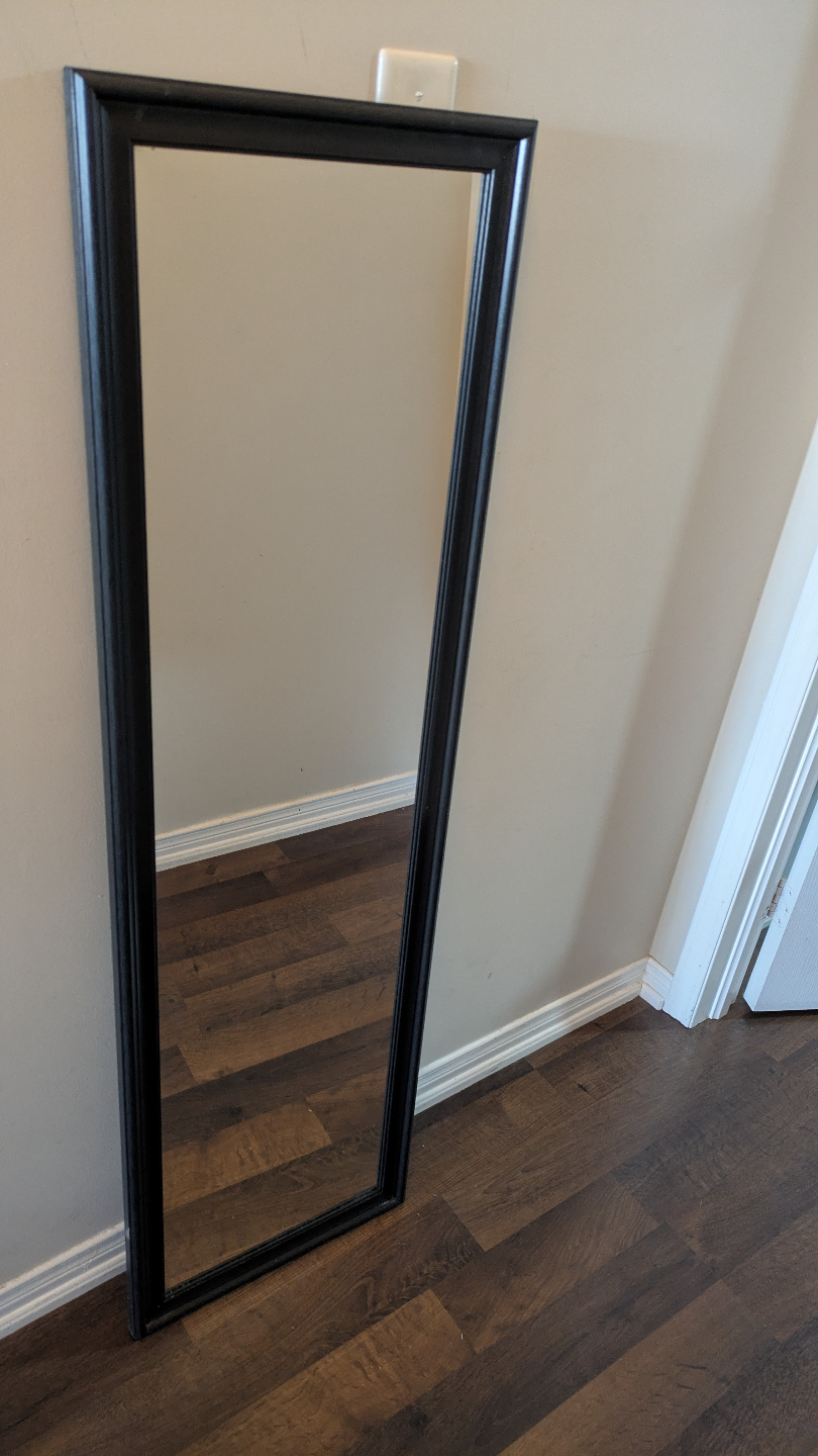 Black framed full-length mirror
