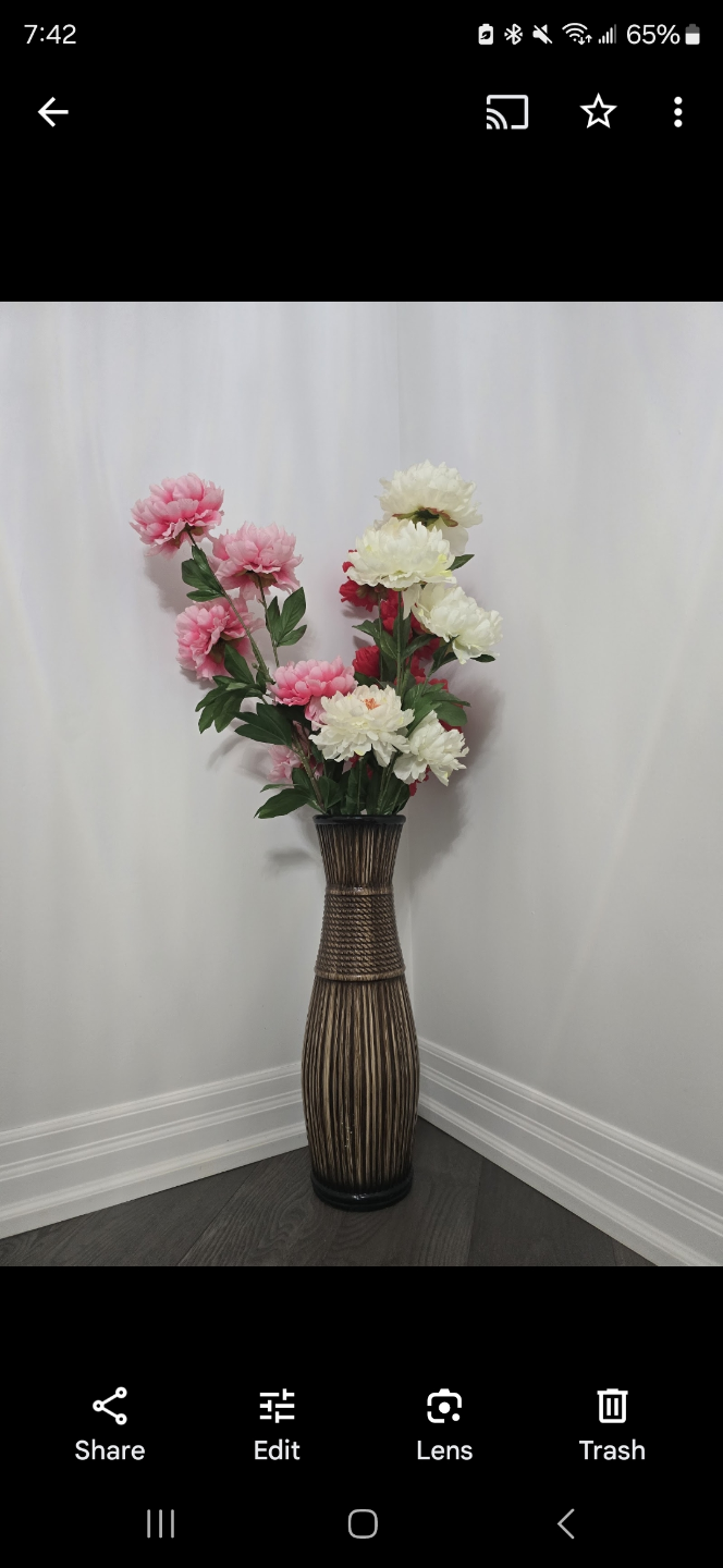 Tall decorative vase with artificial flowers