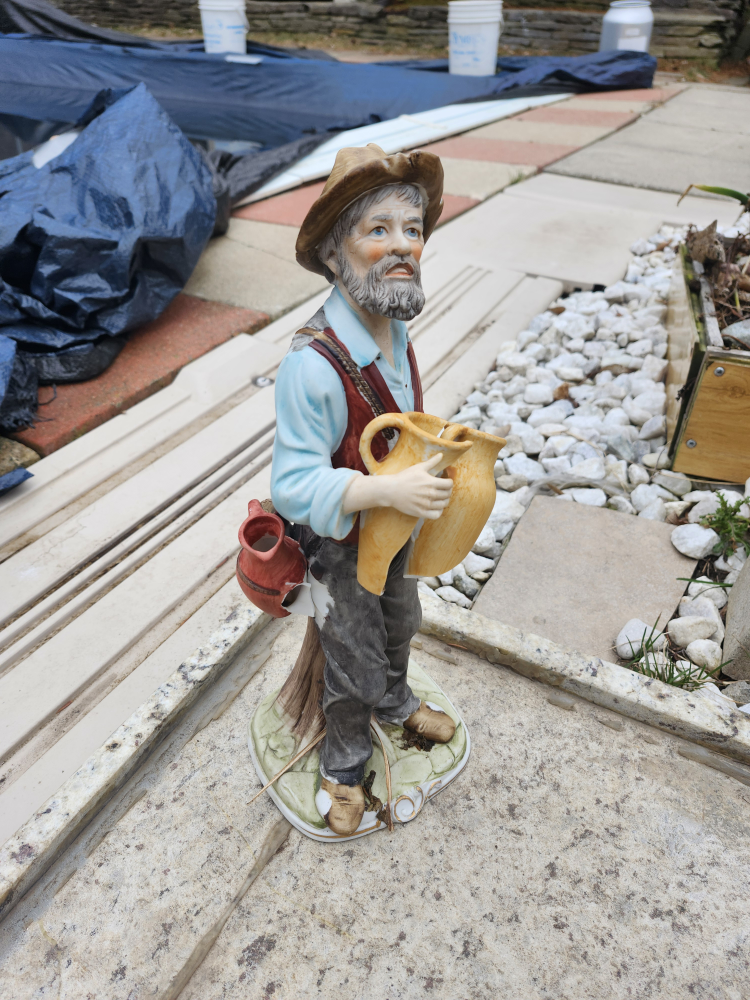Vintage Porcelain Figurine of a Man Carrying Jugs