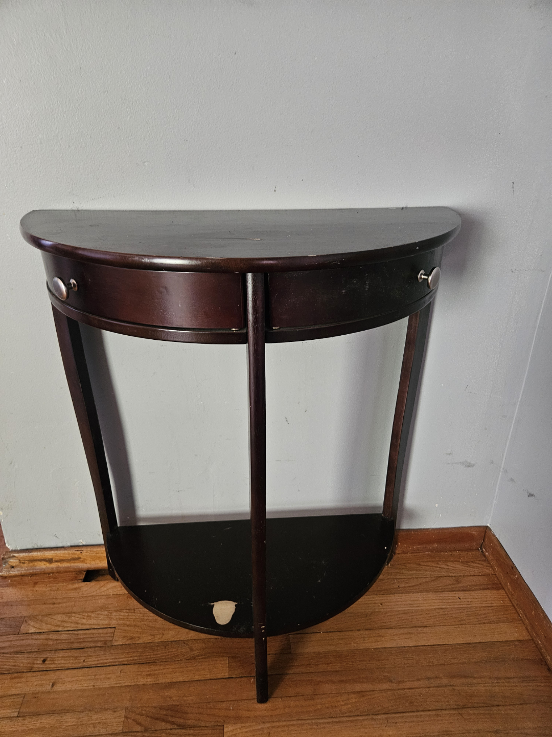 Dark brown half-moon console table