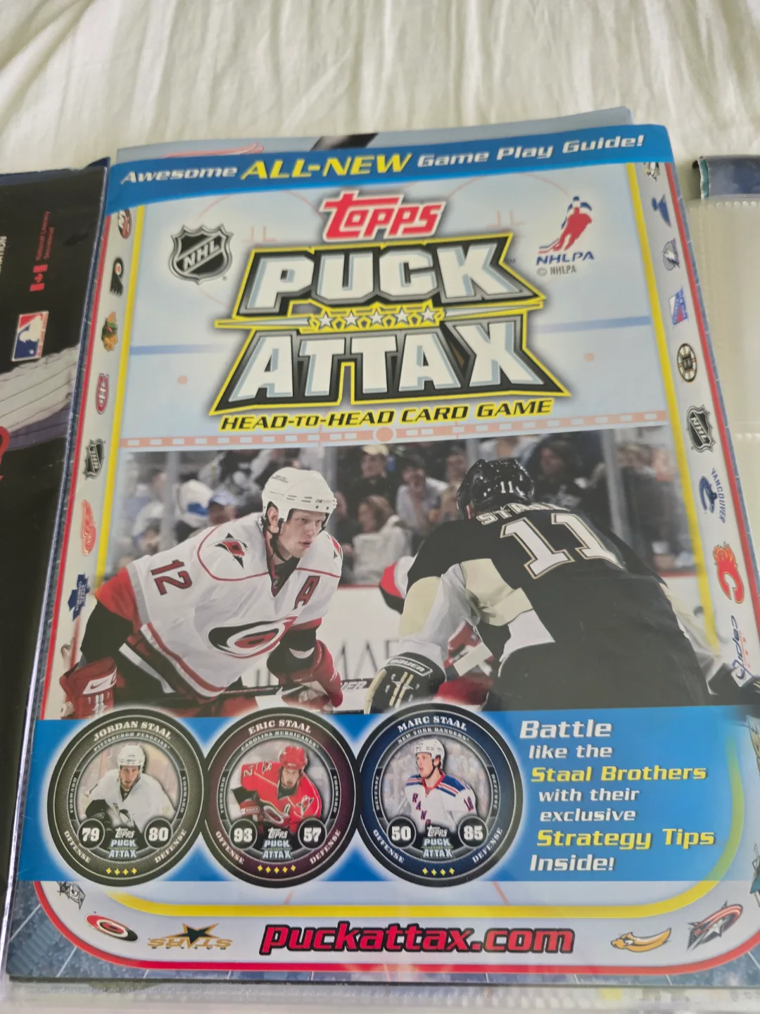 assorted sport posters, cards, pucks and games thumbnail