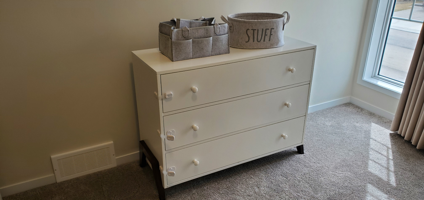 White Three-Drawer Dresser with Dark Brown Legs