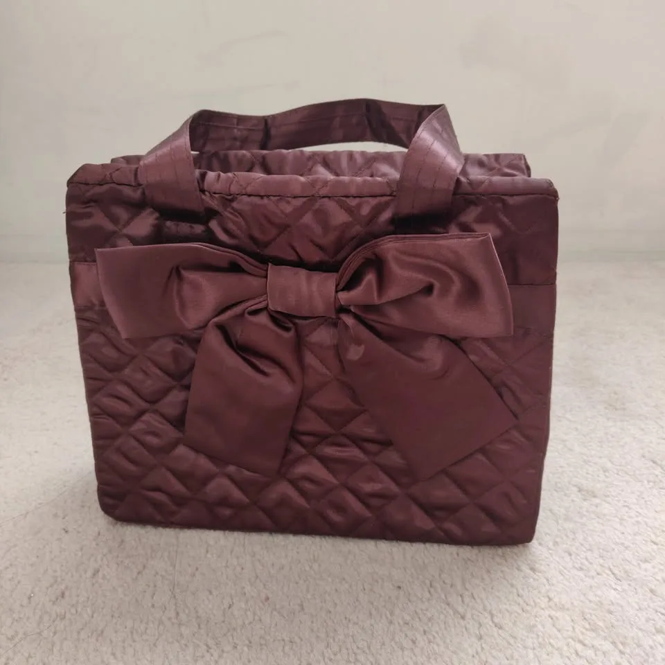 Brown quilted handbag with satin bow thumbnail