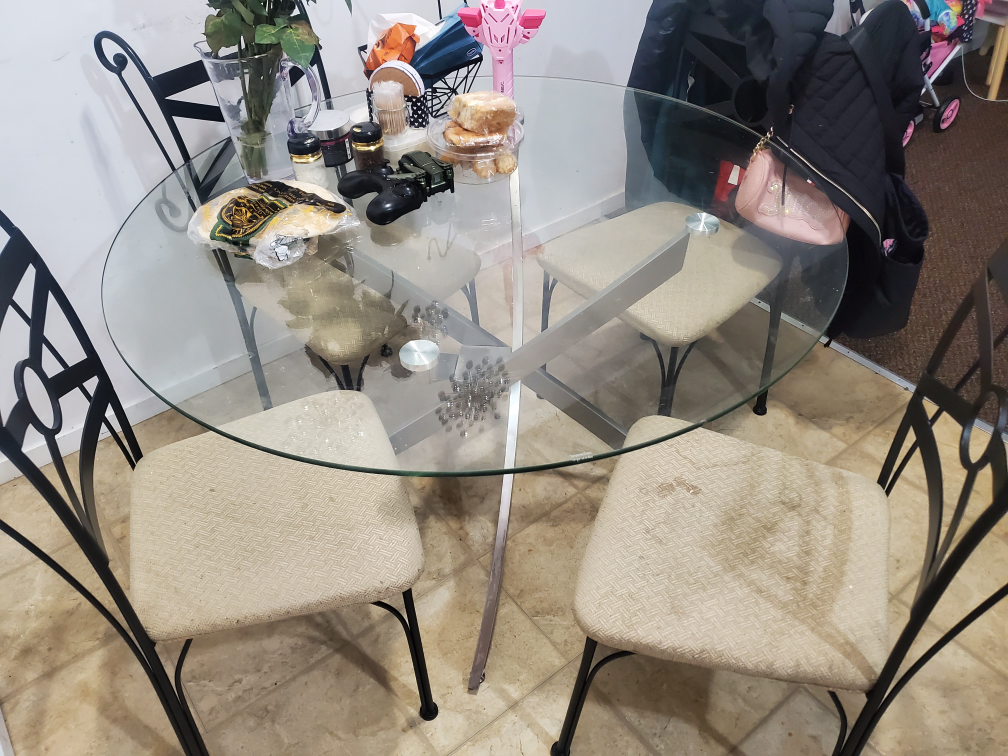 Glass top dining table with four chairs