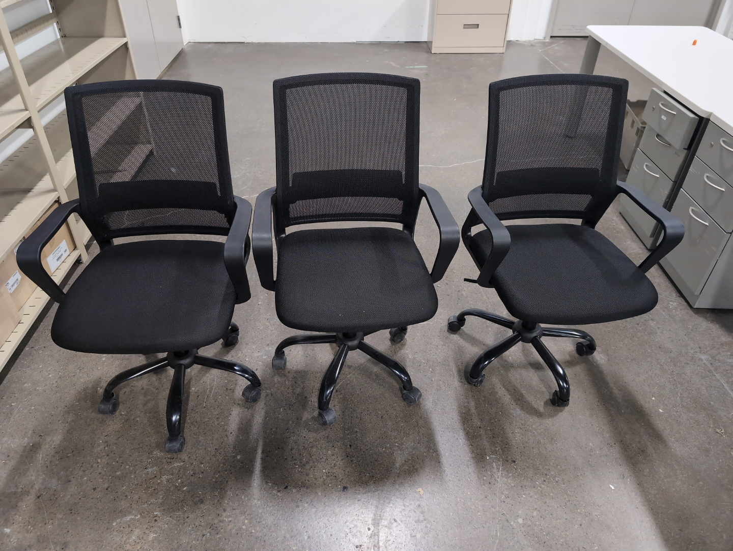 Three Black Mesh Office Chairs
