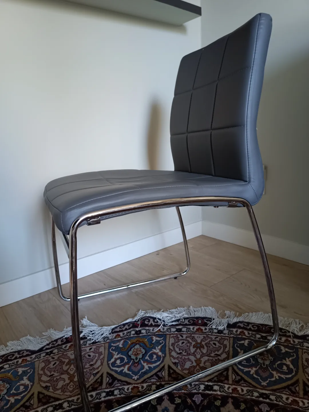 Grey upholstered chair image indicator(2)