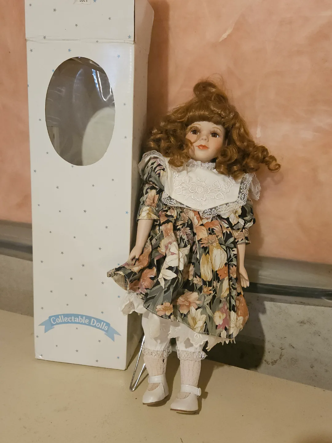 Collectible Porcelain Doll with Floral Dress image indicator(2)