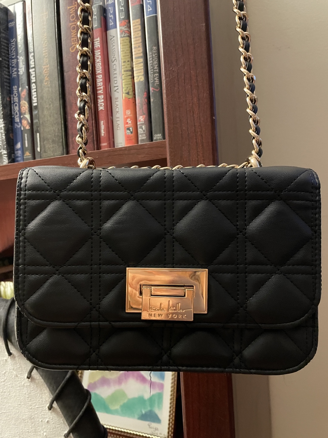 Black quilted crossbody bag with gold chain strap
