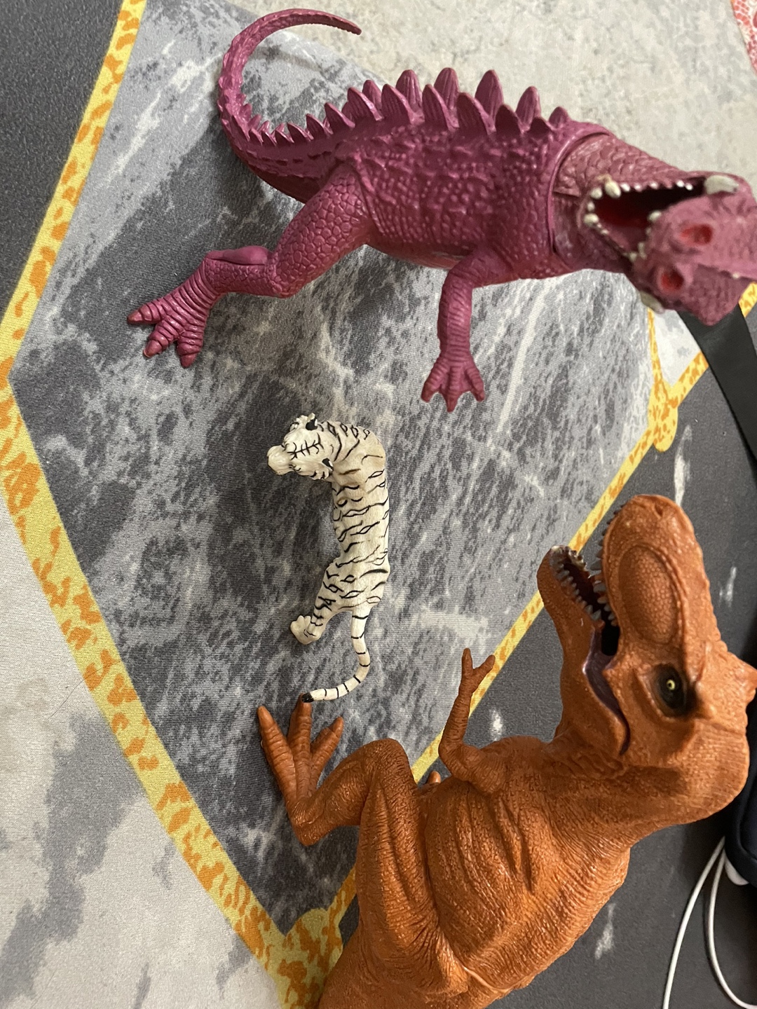 Three Figurines: Dragon, T-Rex, and Tiger