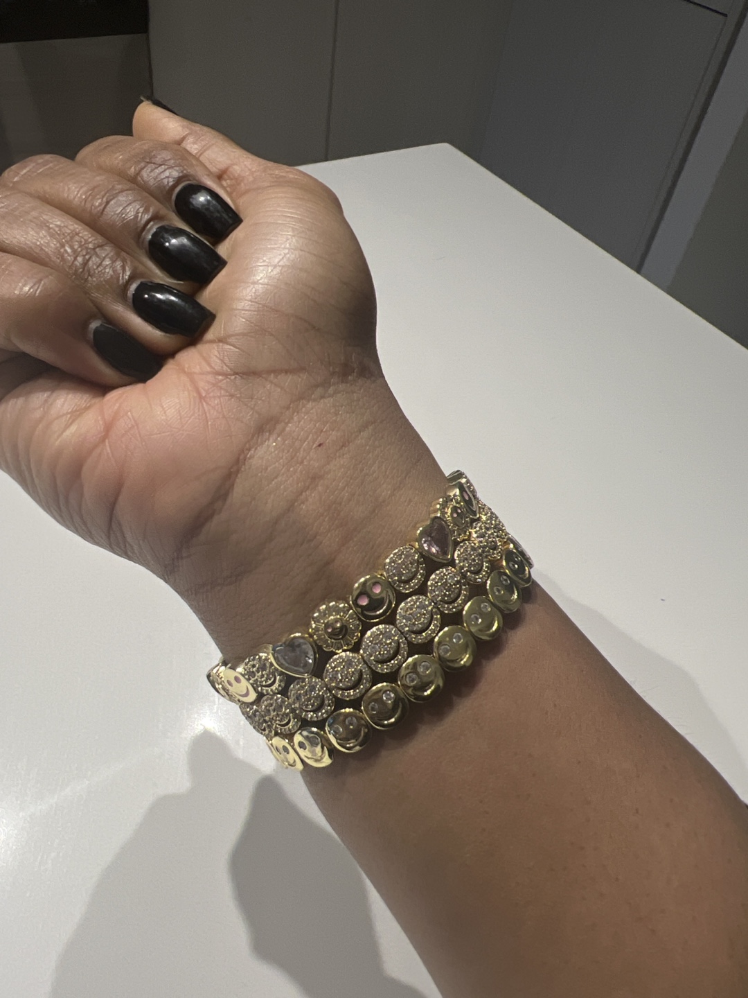 Set of three gold smiley face bracelets