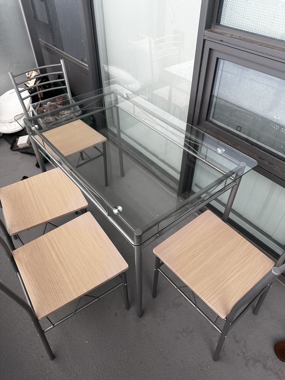 Glass-top patio dining set with four chairs