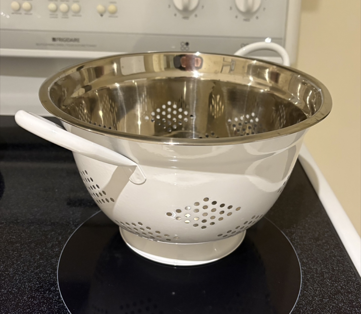 White enamel colander with stainless steel interior