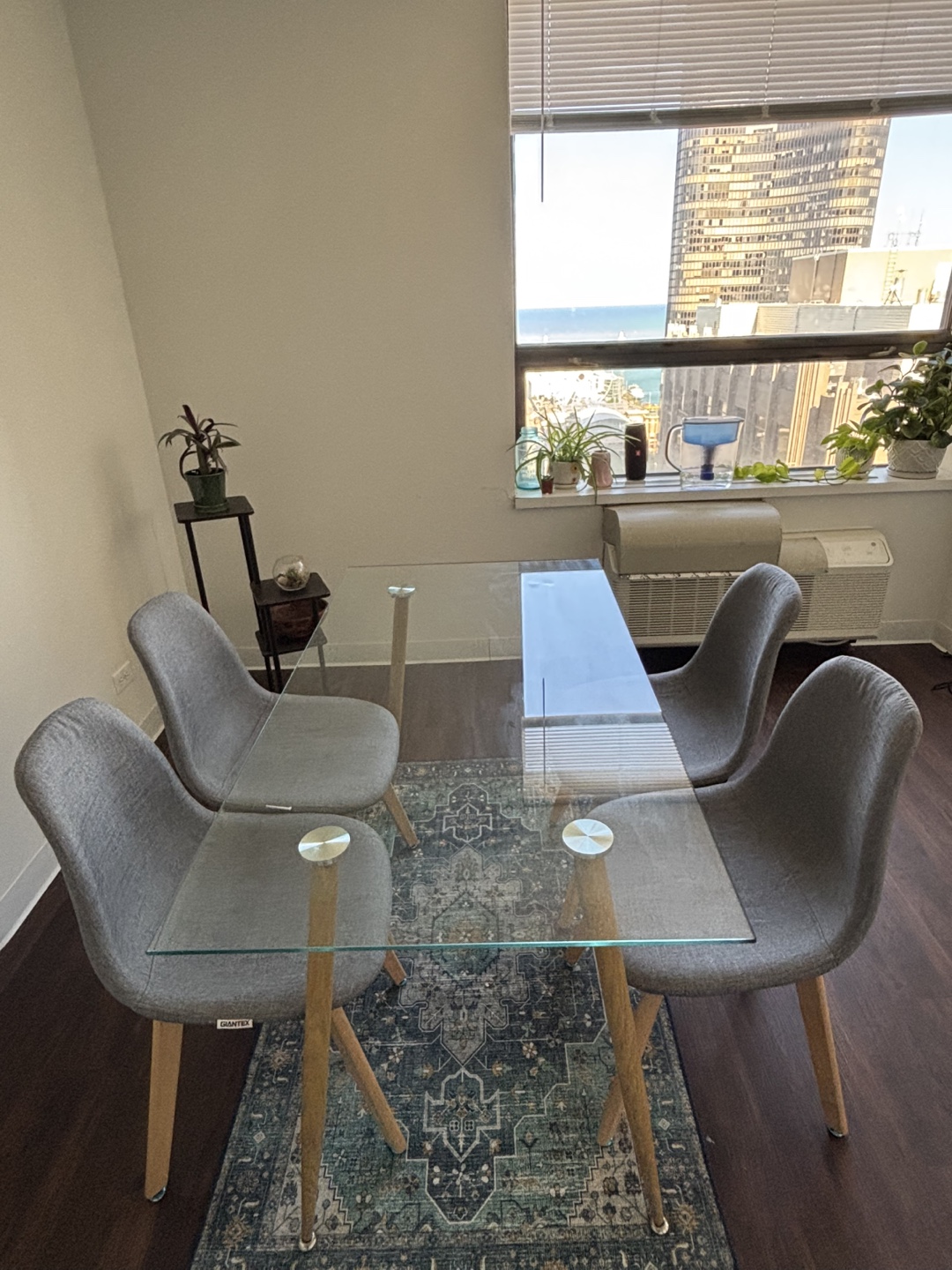 Glass Dining Table with Four Grey Chairs
