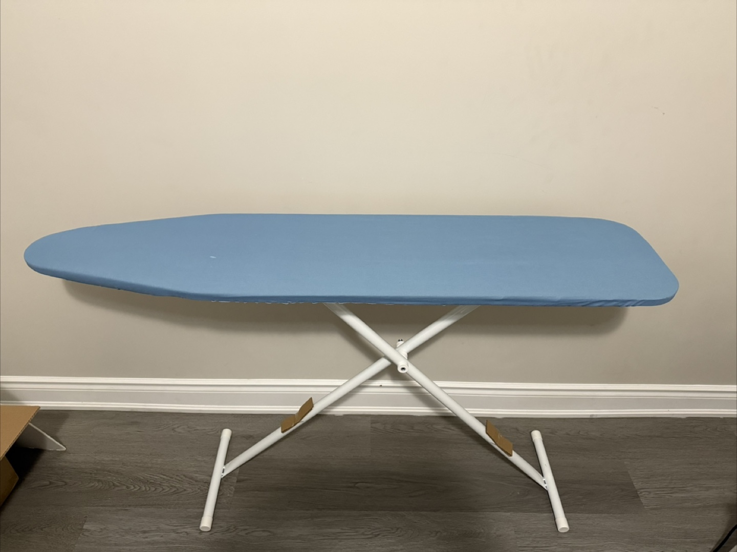 Ironing board with light blue cover