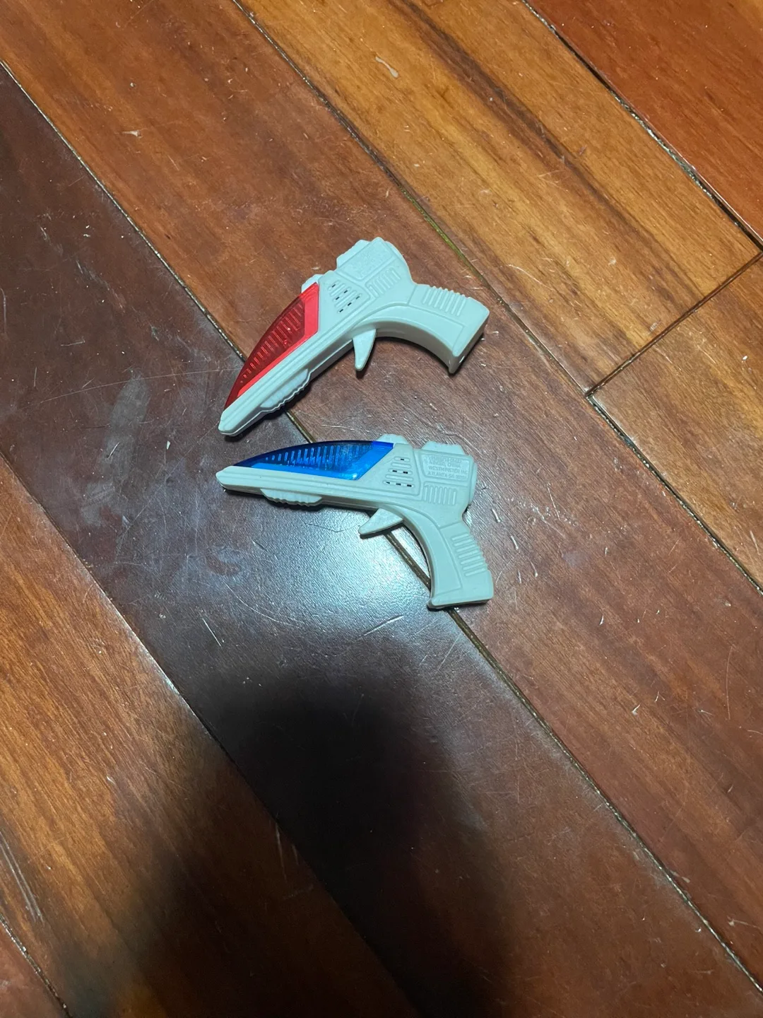 Pair of little light-up toy guns thumbnail