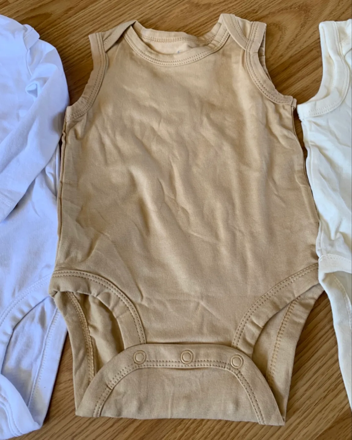 Three Baby Bodysuits - White, Beige, and Cream - 9 Months image indicator(5)