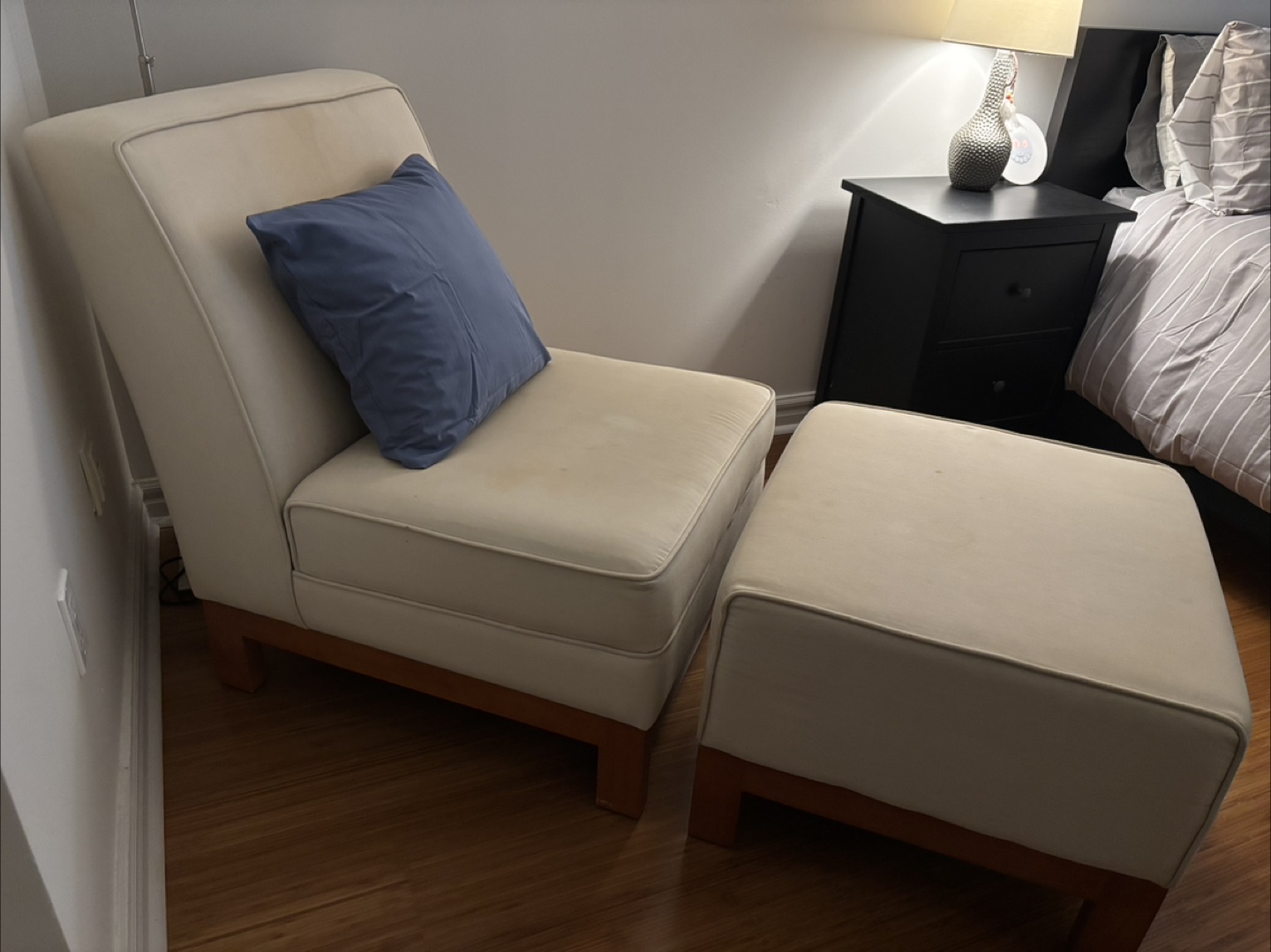 Cream-coloured chair and ottoman set