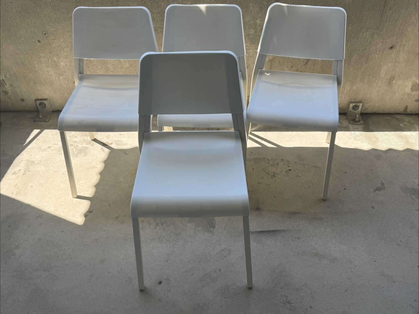 Four White Plastic Chairs