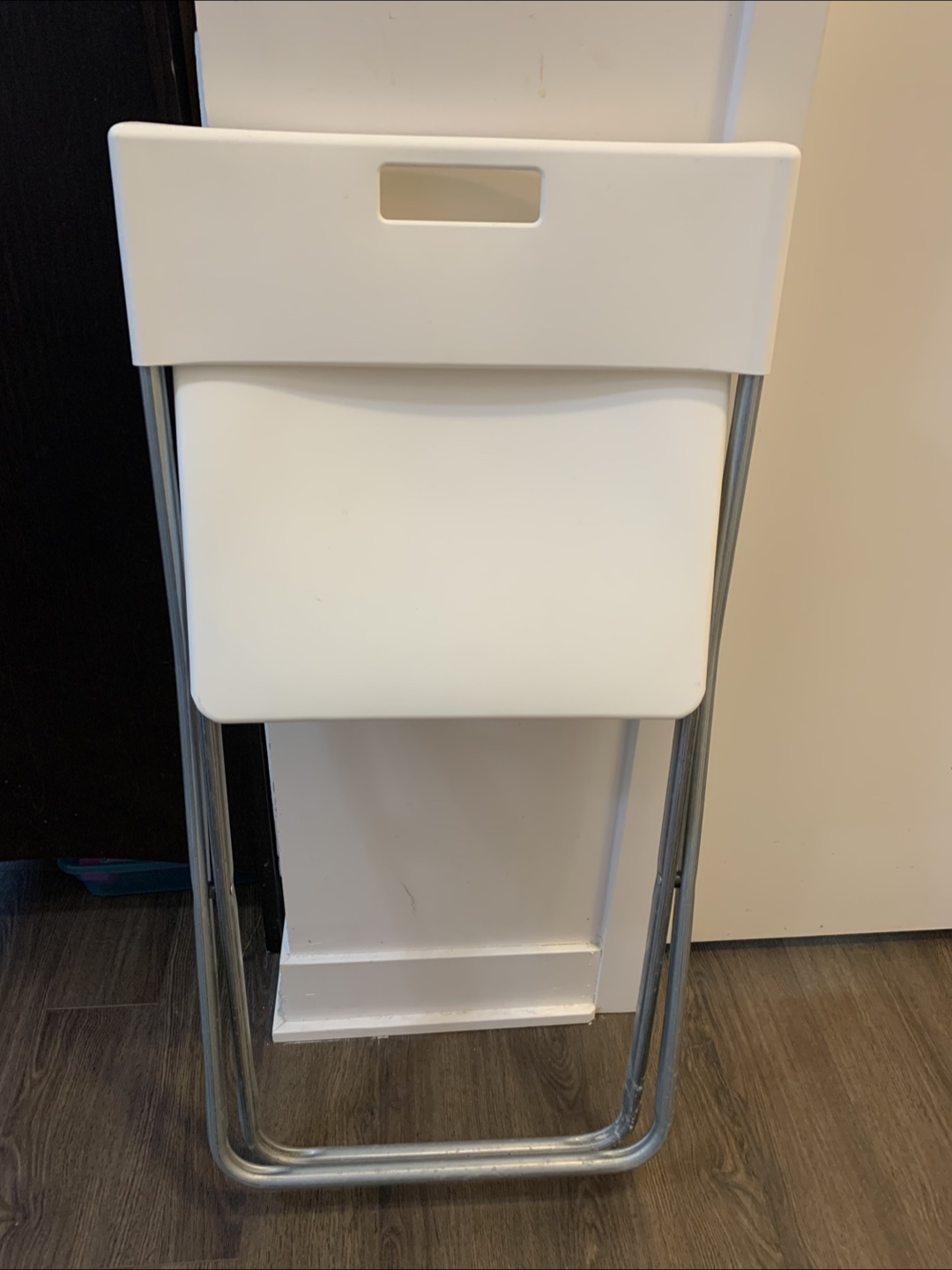 Set of four white folding chairs