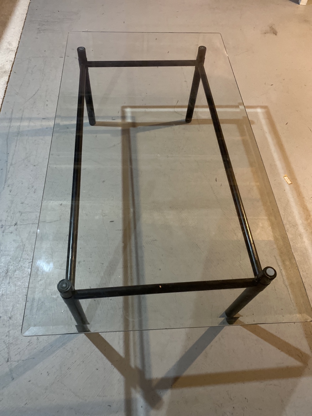 Glass top coffee table with black metal frame