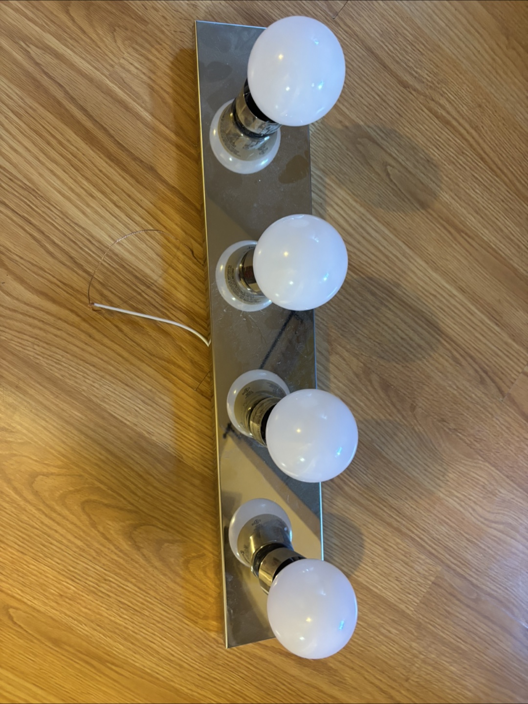 Four-light vanity light fixture