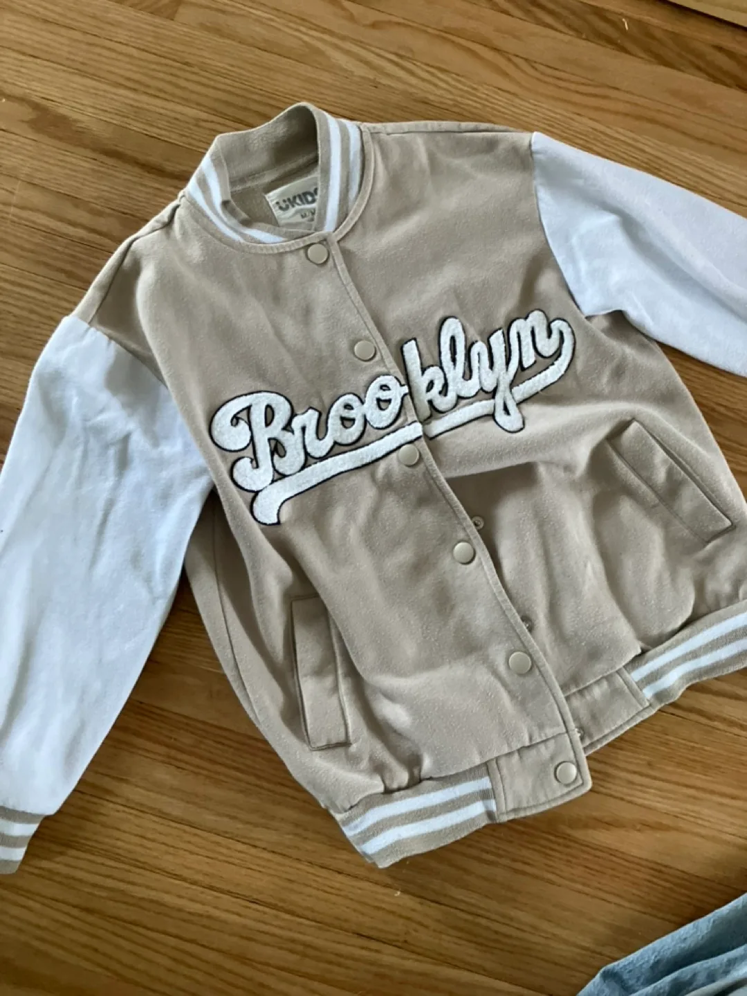 Kids Outfit: Tan Varsity Jacket and Light Wash Denim Overalls image indicator(8)