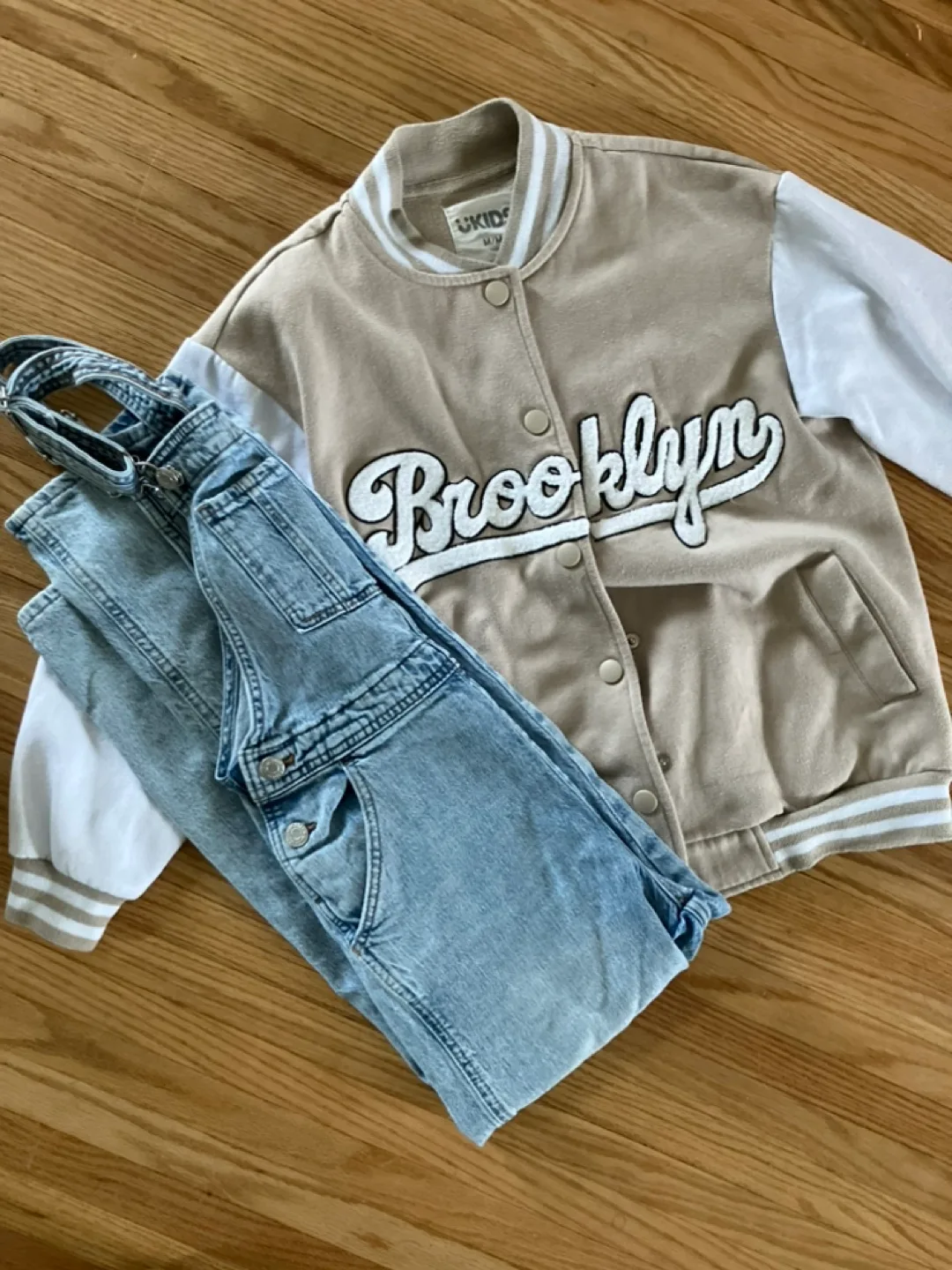 Kids Outfit: Tan Varsity Jacket and Light Wash Denim Overalls image indicator(2)