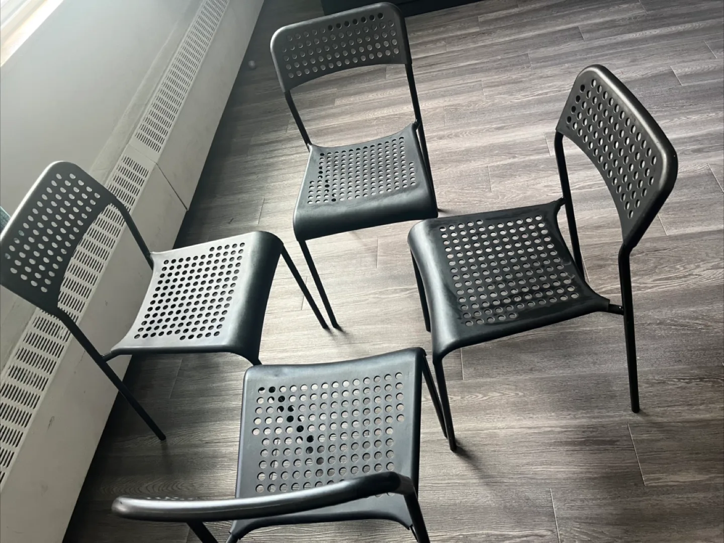 Four Black Plastic Chairs thumbnail