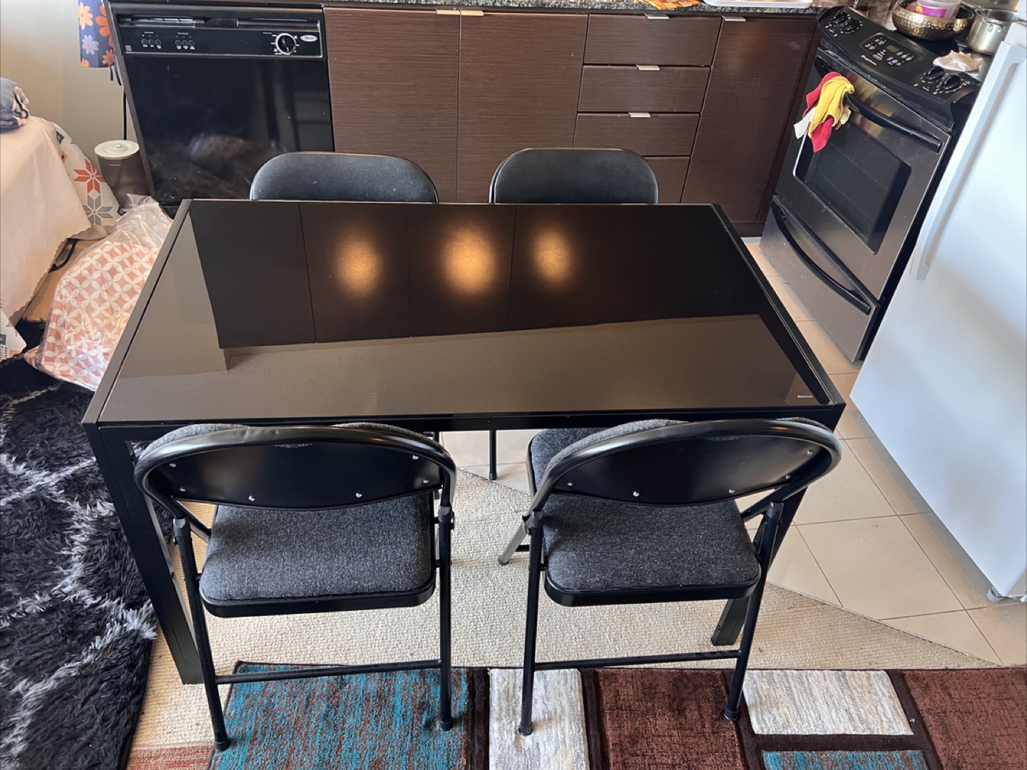 Black Glass Dining Table with Four Folding Chairs - photo 4