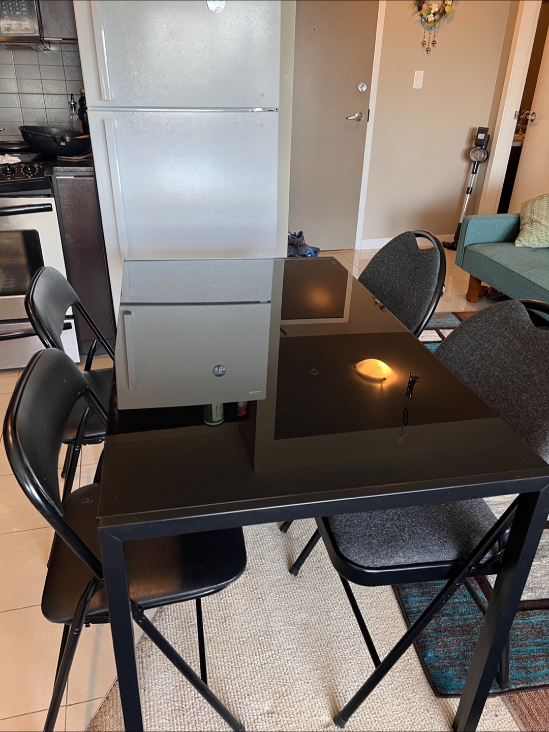 Black Glass Dining Table with Four Folding Chairs
