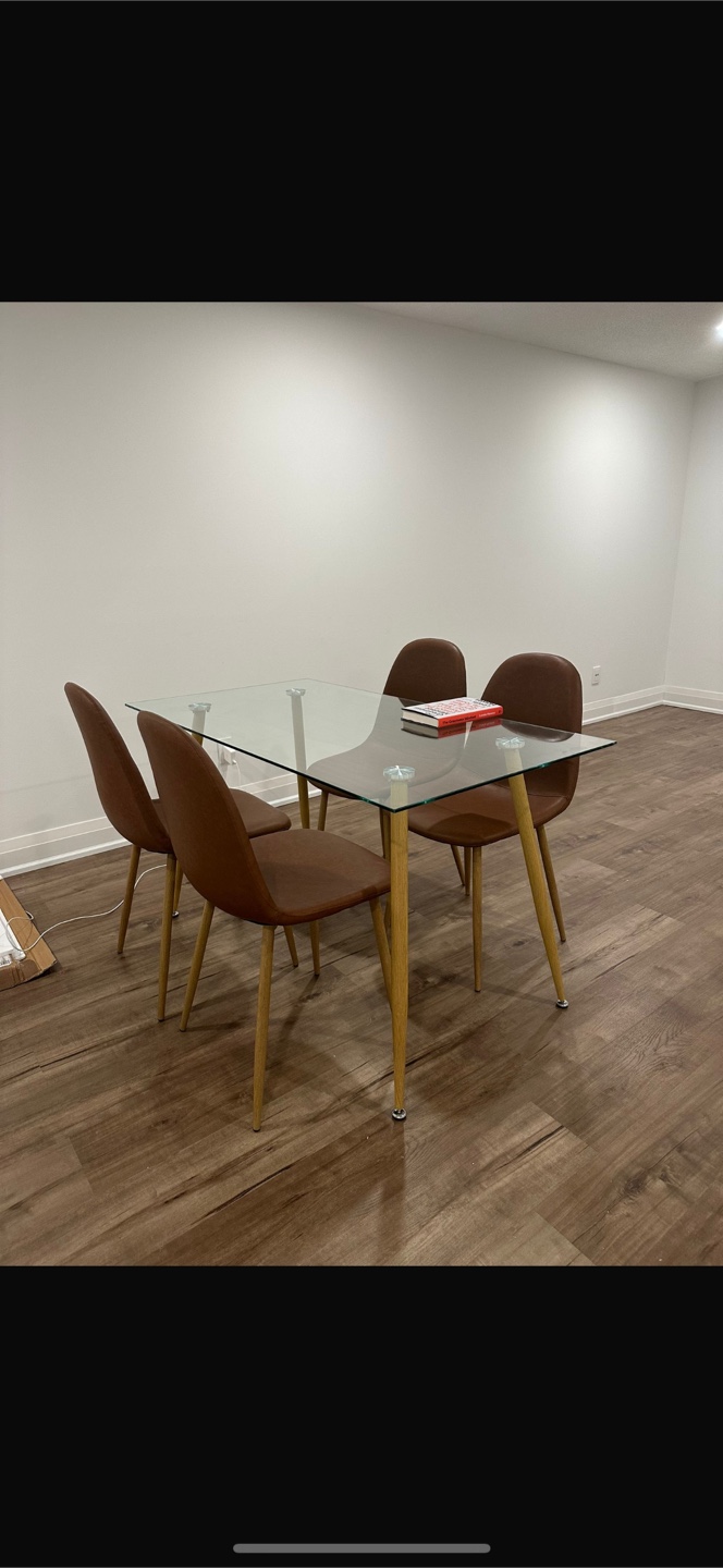 Modern glass-top dining table and four leather chairs