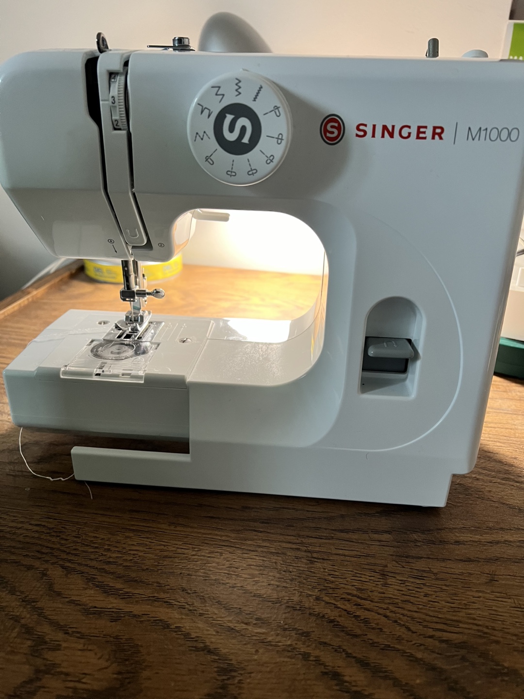 Singer M1000 Sewing Machine With Accessories And Fabrics
