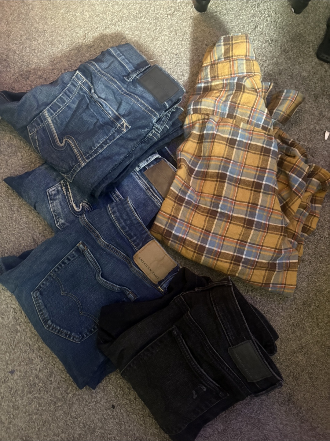 Bundle of Jeans and Flannel Shirt