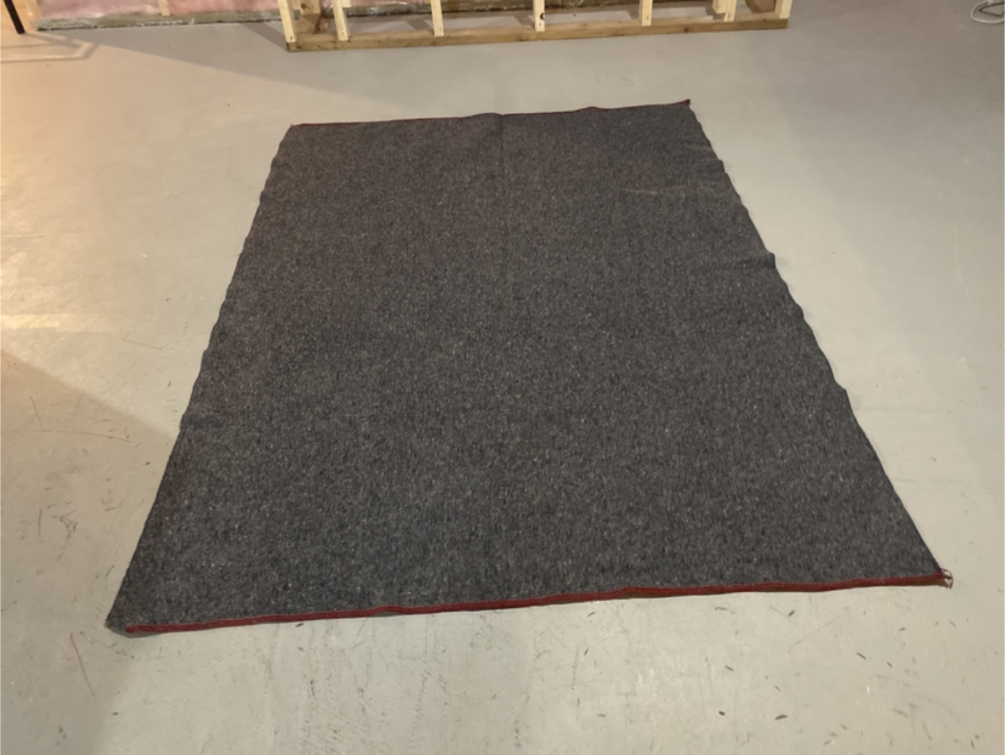 Dark grey area rug with red border