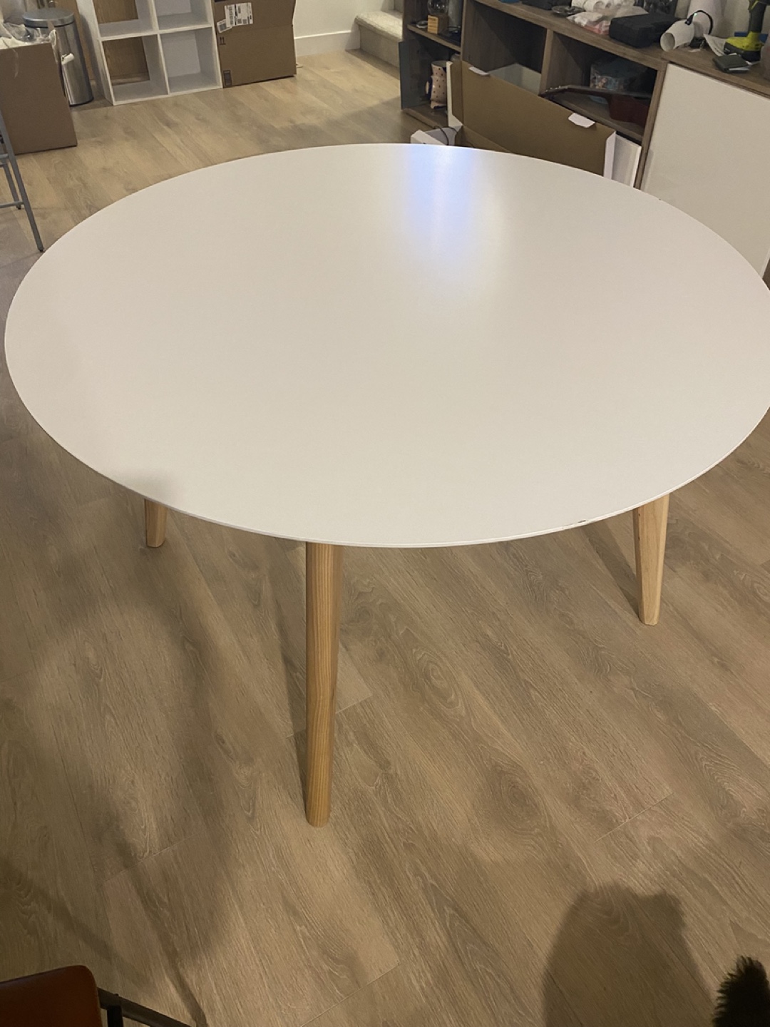 Round White Dining Table with Light Wood Legs