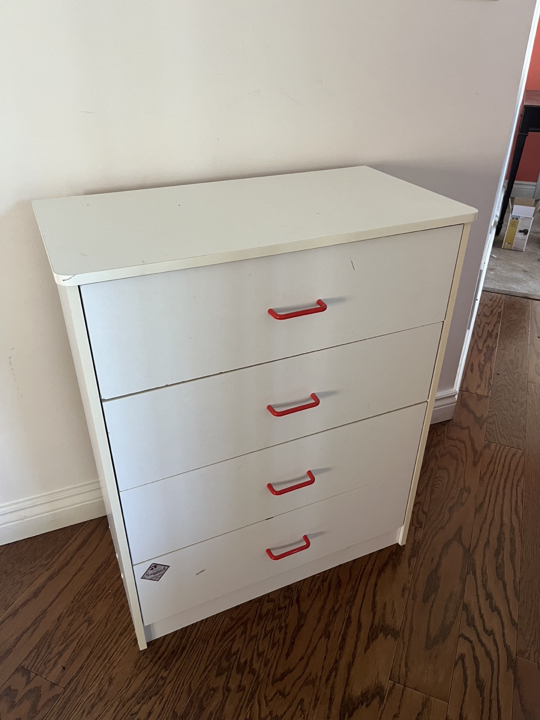 White four-drawer dresser with red handles